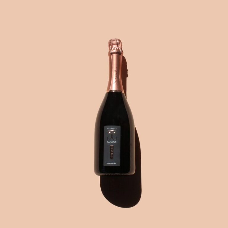 Sparkling wine bottle on peach